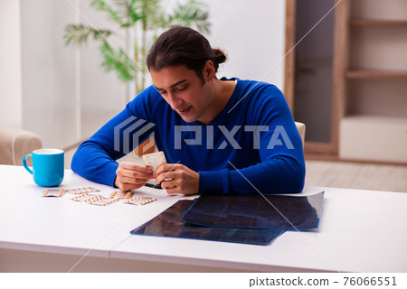 Young sick man suffering at home Young sick man suffering at home 76066551