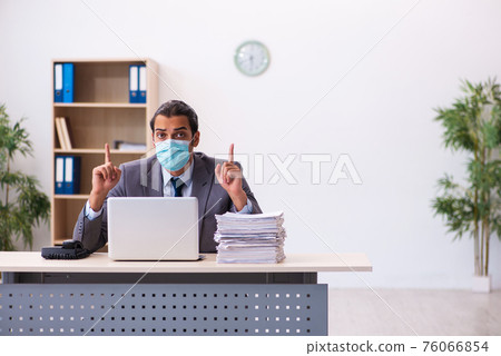 Young male employee wearing mask during pandemic Young male employee wearing mask during pandemic 76066854