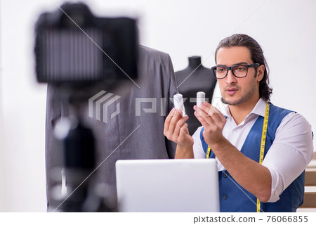 Young male tailor recording video for his blog Young male tailor recording video for his blog 76066855