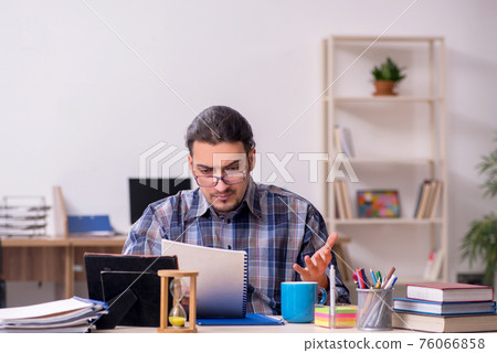 Young male student sitting in the classroom Young male student sitting in the classroom 76066858