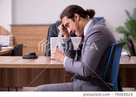 Young businessman employee in bullying concept in the office Young businessman employee in bullying concept in the office 76068028
