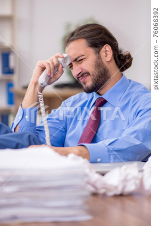 Young male employee in brainstorming concept Young male employee in brainstorming concept 76068392