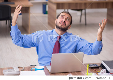 Young male employee in brainstorming concept 76068394