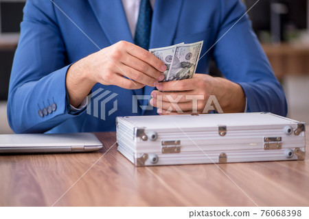 Young male employee in remuneration concept Young male employee in remuneration concept 76068398