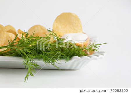 chips with sour cream and dill sauce isolated chips with sour cream and dill sauce isolated 76068890