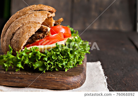grain croissant sandwich on a whiteboard and a dark background grain croissant sandwich on a whiteboard and a dark background 76068892