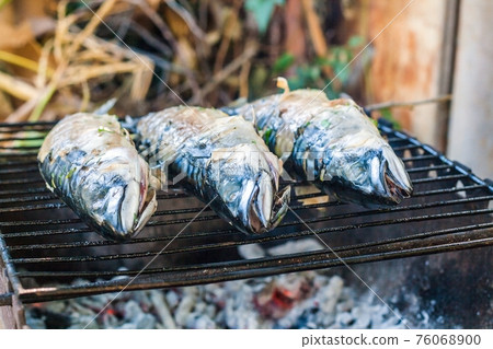 Mackerel fish prepared on the grill in smoke 76068900