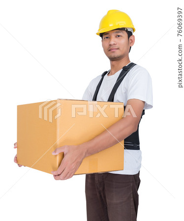 Smiling man lifts a cardboard box wearing back support belt Smiling man lifts a cardboard box wearing back support belt 76069397
