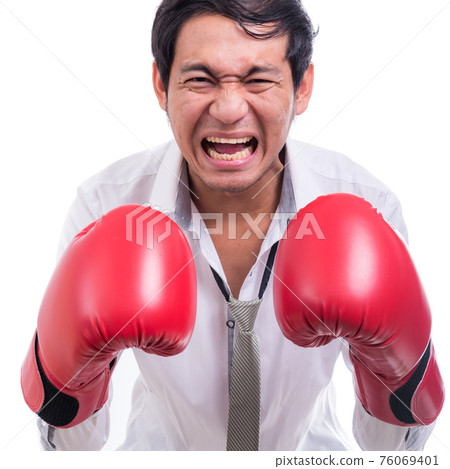 Portrait angry businessman with boxing gloves Portrait angry businessman with boxing gloves 76069401