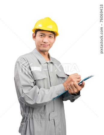 Handsome happy supervisor or technician writing notes Handsome happy supervisor or technician writing notes 76069418