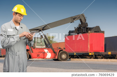 Foreman stand check tablet on front forklift loading Containers box Foreman stand check tablet on front forklift loading Containers box 76069429