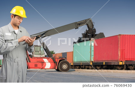 Foreman stand check tablet on front forklift loading Containers box Foreman stand check tablet on front forklift loading Containers box 76069430