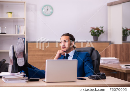 Young male employee working in the office Young male employee working in the office 76070093