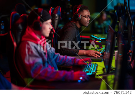 Professional esports players at an online game tournament. The cyber team plays computers and trains 76071142