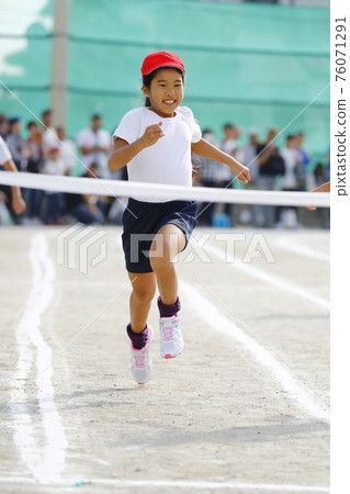 A Girl Running In A Foot Race At An Elementary Stock Photo