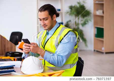 Young male architect working in the office Young male architect working in the office 76071397