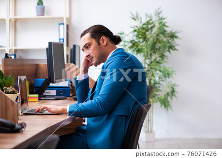 Young male employee working in the office 76071426