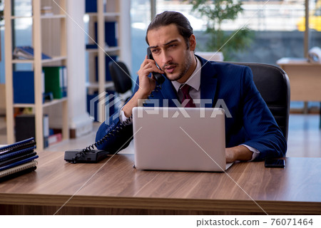 Young businessman employee working in the office Young businessman employee working in the office 76071464