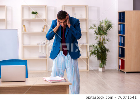 Young male employee in oversleeping concept in front of whiteboa 76071541