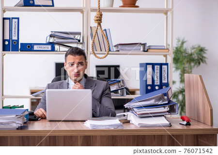 Young male employee committing suicide at workplace 76071542