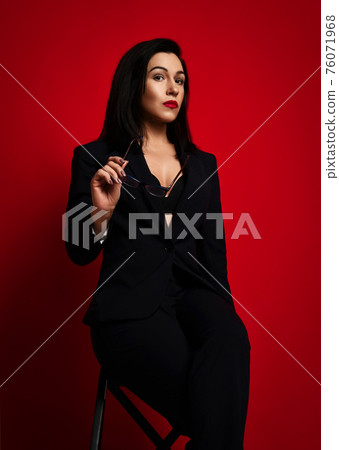 Businesswoman in official pantsuit with deep 76071968