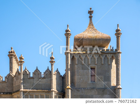 The walls and towers of the old palace on the background of a blue sky The walls and towers of the old palace on the background of a blue sky 76072162