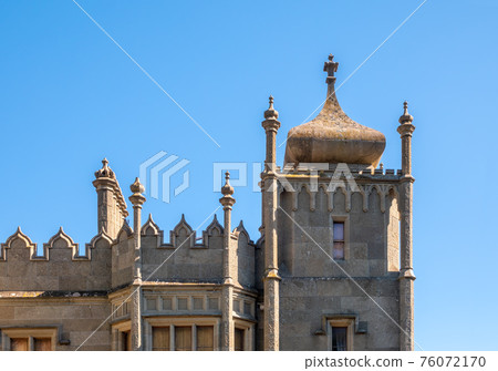 The walls and towers of the old palace on the background of a blue sky The walls and towers of the old palace on the background of a blue sky 76072170