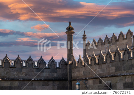 The walls and towers of the old palace on the background of beautiful pink sunset The walls and towers of the old palace on the background of beautiful pink sunset 76072171