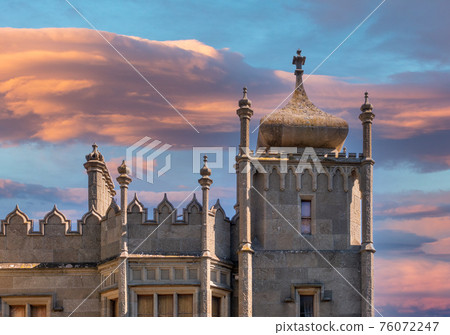 The walls and towers of the old palace on the background of beautiful pink sunset The walls and towers of the old palace on the background of beautiful pink sunset 76072247