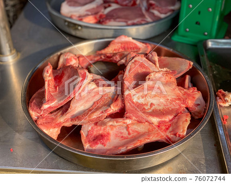 Pile of pork bone for sale at raw meat market  76072744