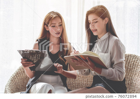 Young Asian. women Business people meeting point to discuss, plan. Young Asian. women Business people meeting point to discuss, plan. 76072894