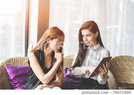 Young Asian. women Business people meeting point to discuss, plan. Young Asian. women Business people meeting point to discuss, plan. 76072899