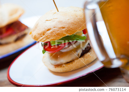 Beef burger served in cafe 76073114