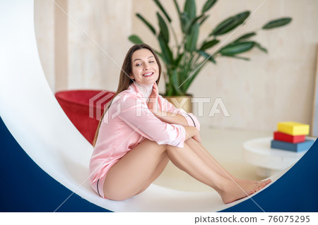 Long-haired pretty woman in pink lingerie spending her day in spa salon Long-haired pretty woman in pink lingerie spending her day in spa salon 76075295