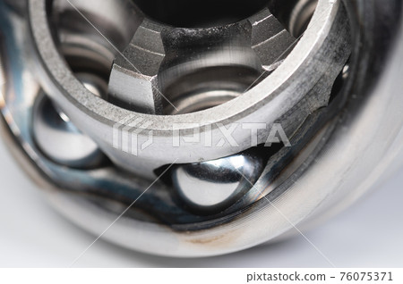 Close-up constant-velocity universal spheric joint new on gray background 76075371