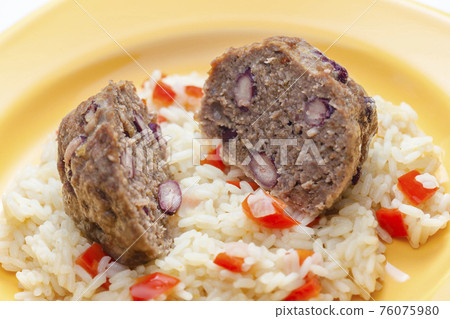 meat balls filled with red beans on rice with red pepper 76075980