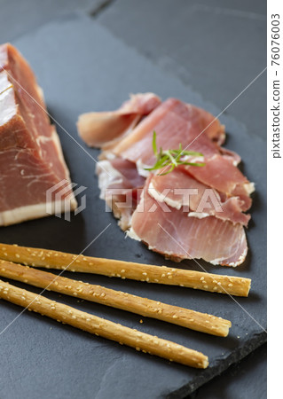 Italian ham served with grissini Italian ham served with grissini 76076003