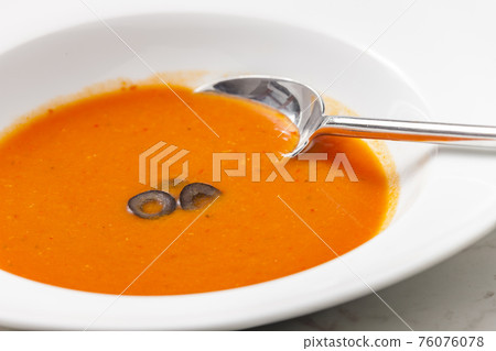 typical Spanish soup gazpacho with black olives 76076078
