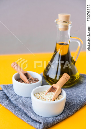 Sesame and flax seeds wooden spoons with oil in glass bottle. Healthy food concept. Vegan keto diet. Linseed oil. Sesame oil Minimalistic concept in isometric style in trendy colors. 76076221