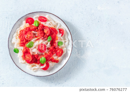 Konjac pasta with tomatoes, low-calorie vegan meal, shot from above 76076277