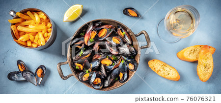 Mussels panorama with wine, fries, and toasts 76076321