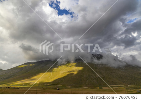 Dramatic mountain landscape near Castelluccio village in National Park Monte Sibillini, Umbria region, Italy Dramatic mountain landscape near Castelluccio village in National Park Monte Sibillini, Umbria region, Italy 76076453