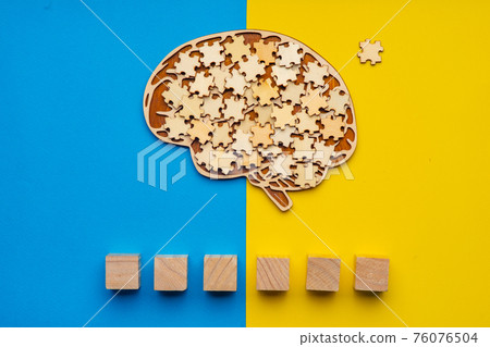 Mock up of a human brain with scattered puzzle pieces Mock up of a human brain with scattered puzzle pieces 76076504