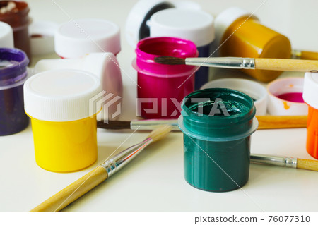 mixed gouache paints and paint brushes 76077310