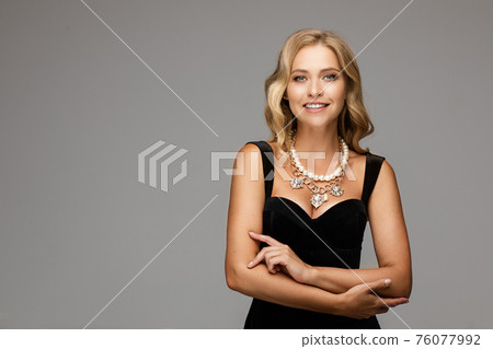 Mirthful lady in the evening outlook posing and Mirthful lady in the evening outlook posing and 76077992