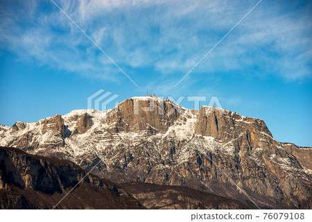 Snow Capped Mountain Range of the Paganella in Winter - Alps Trentino Italy 76079108