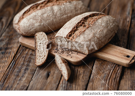 Homemade hearth bread on a wooden table. 76080000