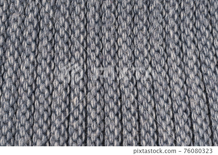 Close-up structure of a knitted product. Scarf, hat or sweater with a chunky knit. Background, texture 76080323