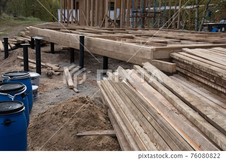 Construction site. The basis of a wooden house. Construction of the pile. Construction site. The basis of a wooden house. Construction of the pile. 76080822