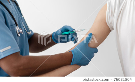 Medical staff make injection to arm muscle to build immunization of coronavirus covid-19 Medical staff make injection to arm muscle to build immunization of coronavirus covid-19 76081804
